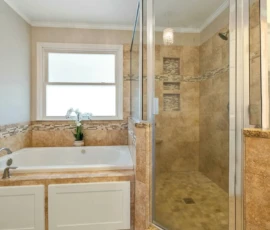 Bathroom Remodel - Image is of a simple shower and tub with a brown accent